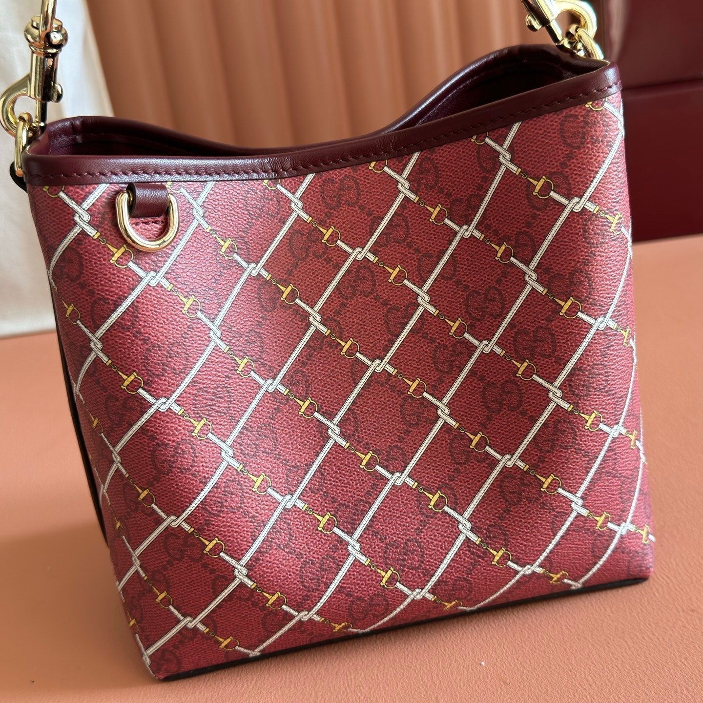 GUCCI 26S  EMBLEM BUCKET BAG 19 IN DARK RED COATED FABRIC
